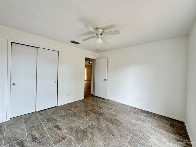 unfurnished bedroom with a closet and ceiling fan