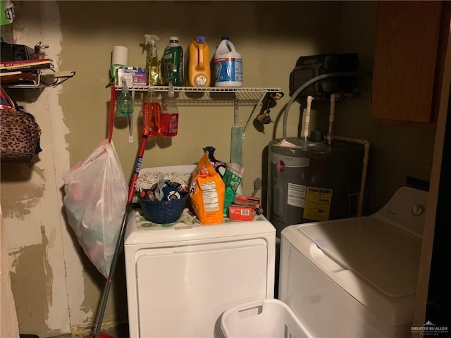 laundry area with washer and clothes dryer and electric water heater