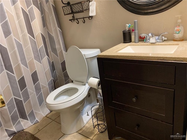 bathroom featuring tile patterned floors, vanity, and toilet