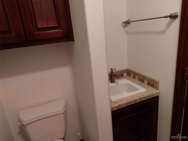 half bath featuring toilet and vanity