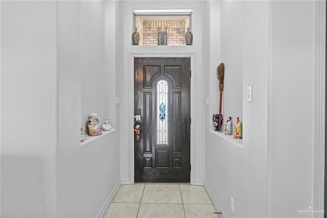 foyer entrance with light tile patterned floors