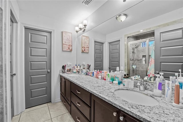 bathroom with vanity, tile patterned floors, and a shower with shower door