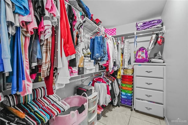 walk in closet featuring light tile patterned flooring