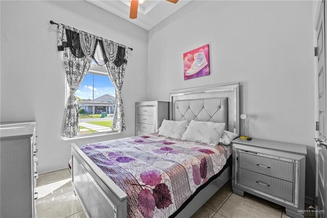 tiled bedroom featuring ceiling fan