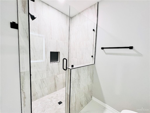 bathroom with a shower with door