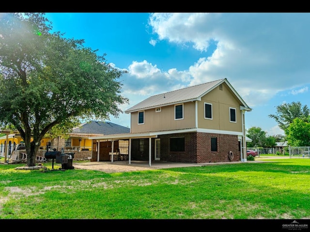 rear view of property with a patio area and a yard