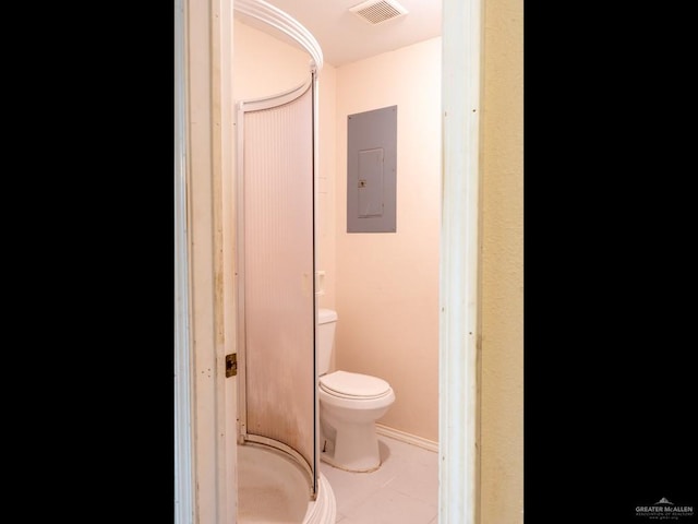 bathroom featuring tile patterned flooring, electric panel, and toilet