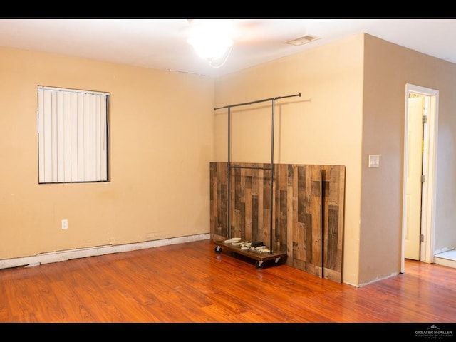 unfurnished room with hardwood / wood-style floors