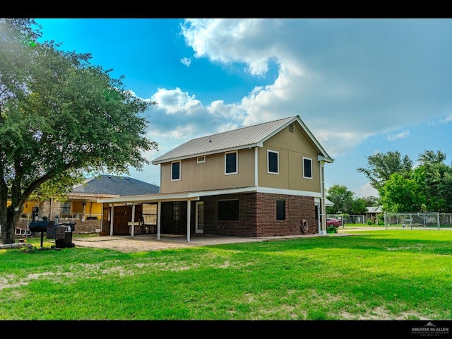 back of property featuring a patio and a lawn