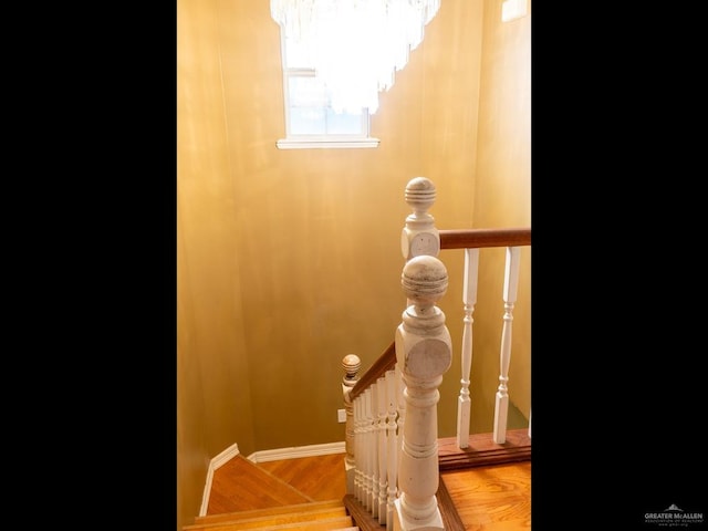 details featuring hardwood / wood-style floors and an inviting chandelier