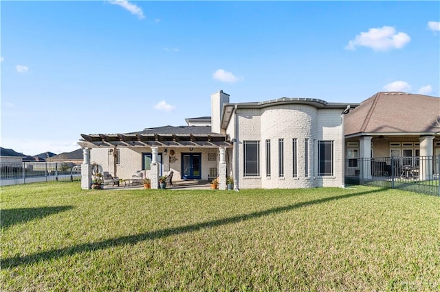 705 W Vinson Ave, Harlingen, TX 78550 - rear view of house featuring a pergola, a patio area, and a lawn