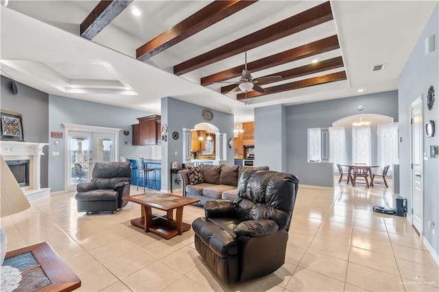 705 W Vinson Ave, Harlingen, TX 78550 - living room with beam ceiling, a raised ceiling, ceiling fan with notable chandelier, and light tile patterned floors