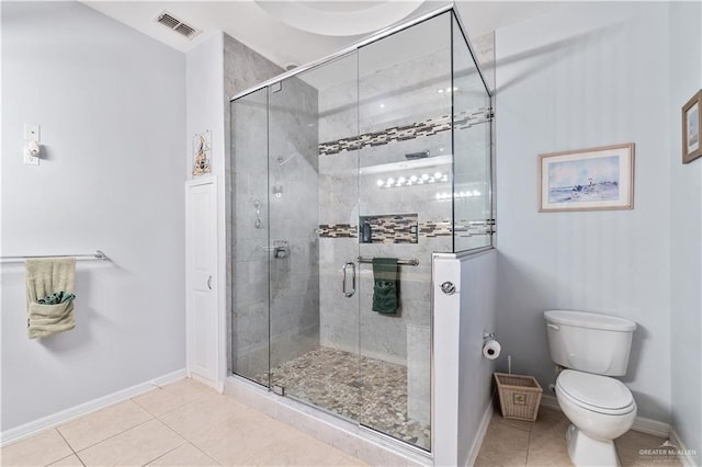 705 W Vinson Ave, Harlingen, TX 78550 - bathroom with a shower with shower door, tile patterned floors, and toilet