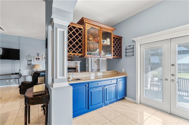 705 W Vinson Ave, Harlingen, TX 78550 - bar with sink, blue cabinetry, a wealth of natural light, light tile patterned flooring, and french doors