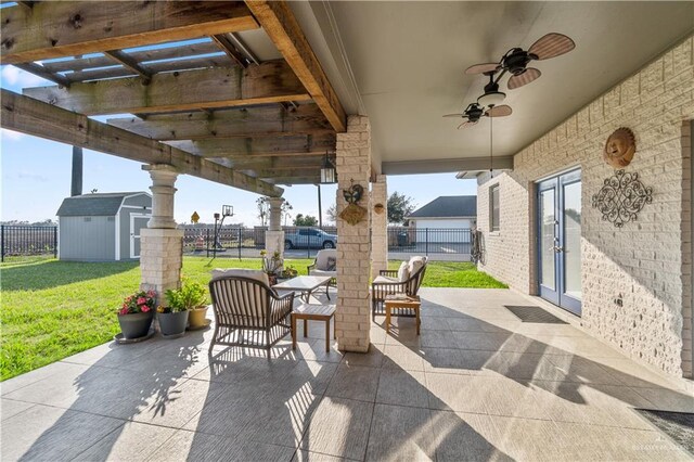 705 W Vinson Ave, Harlingen, TX 78550 - view of patio / terrace featuring french doors, ceiling fan, and a shed
