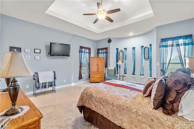 705 W Vinson Ave, Harlingen, TX 78550 - bedroom featuring light tile patterned flooring, a raised ceiling, and multiple windows