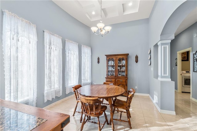 705 W Vinson Ave, Harlingen, TX 78550 - dining space with coffered ceiling, washer / dryer, an inviting chandelier, light tile patterned floors, and decorative columns
