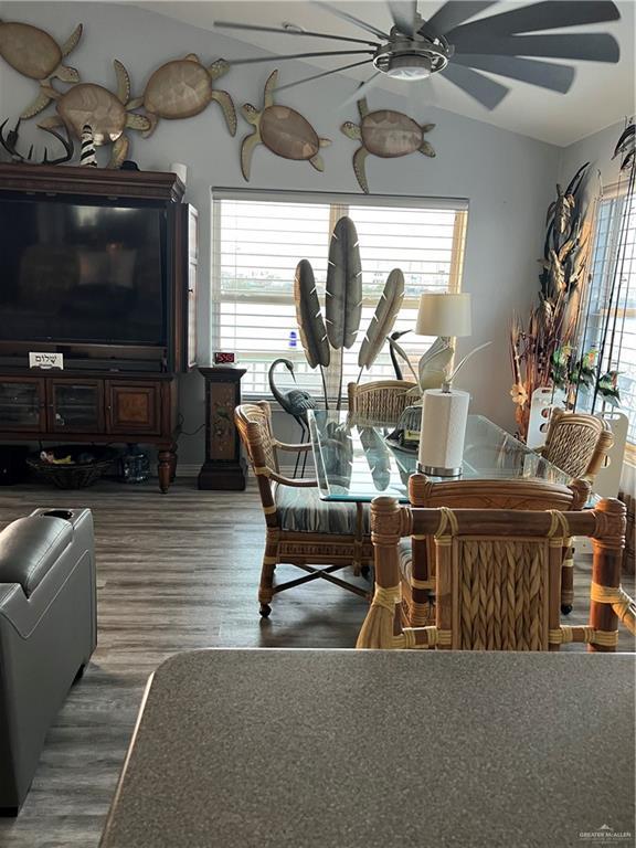 dining space with ceiling fan, wood finished floors, and a wealth of natural light