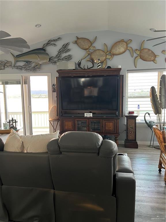 living room with vaulted ceiling and wood finished floors