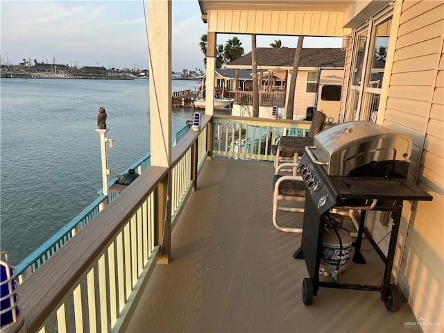 exterior space with a water view and a grill