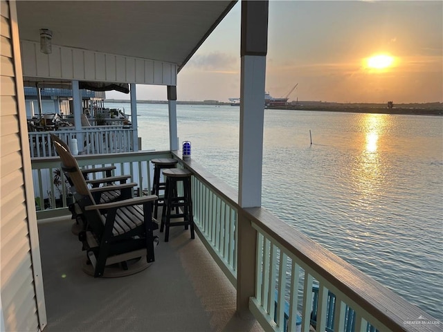 view of dock with a water view and a balcony