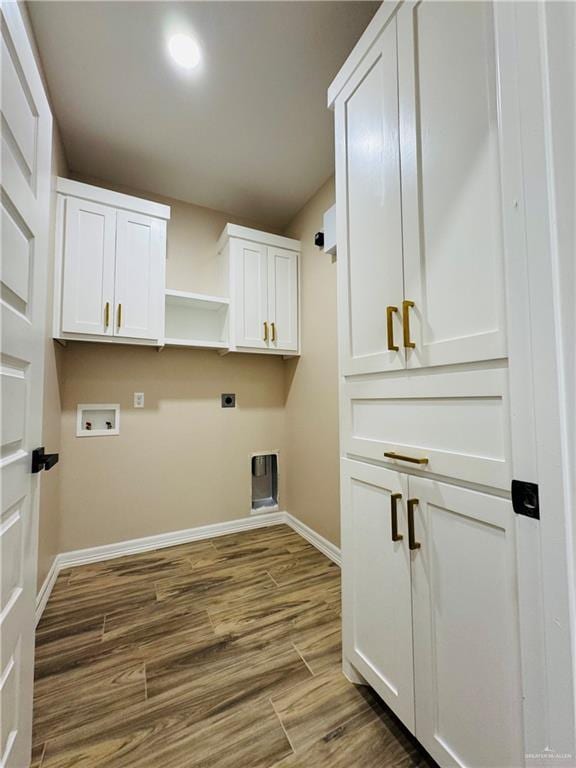 laundry area with cabinets, hookup for an electric dryer, dark hardwood / wood-style flooring, and hookup for a washing machine