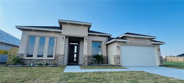 view of front of property with a garage and a front yard