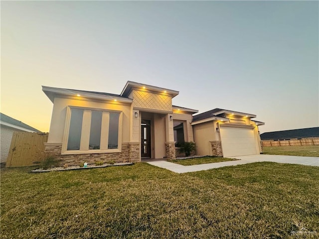 view of front of property featuring a garage and a yard