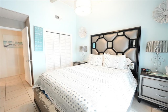 6608 Padre Blvd, South Padre Island, TX 78597 - bedroom with tile patterned floors, a closet, and a high ceiling