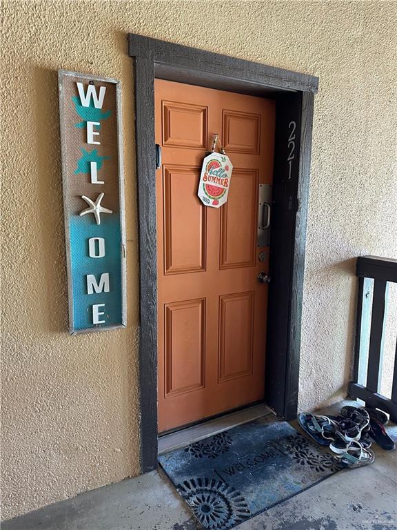 6608 Padre Blvd, South Padre Island, TX 78597 - doorway to property featuring stucco siding