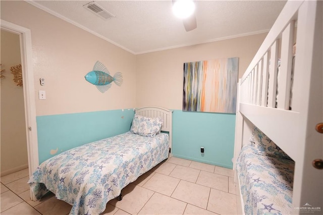 6608 Padre Blvd, South Padre Island, TX 78597 - bedroom with crown molding, tile patterned floors, ceiling fan, and a textured ceiling