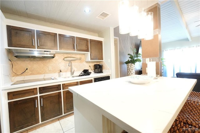 6608 Padre Blvd, South Padre Island, TX 78597 - kitchen featuring under cabinet range hood, electric cooktop, decorative backsplash, light countertops, and white dishwasher