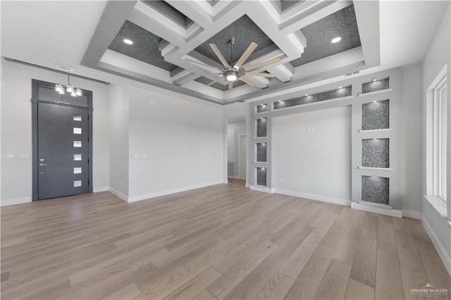 unfurnished living room with light wood-type flooring, ceiling fan with notable chandelier, coffered ceiling, and beamed ceiling