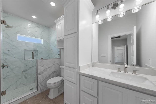 bathroom with toilet, vanity, and walk in shower