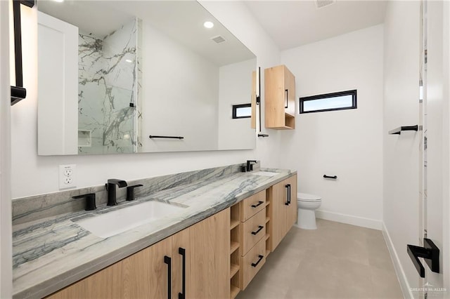1620 S Ongar Ln, Edinburg, TX 78539 - full bathroom featuring baseboards, a marble finish shower, toilet, and double vanity