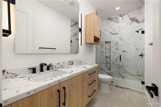 1620 S Ongar Ln, Edinburg, TX 78539 - full bathroom featuring a marble finish shower, toilet, vanity, and recessed lighting