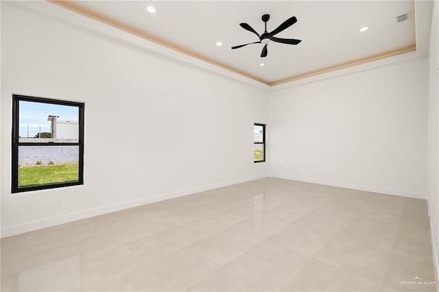 1620 S Ongar Ln, Edinburg, TX 78539 - empty room with plenty of natural light, a ceiling fan, recessed lighting, a raised ceiling, and baseboards