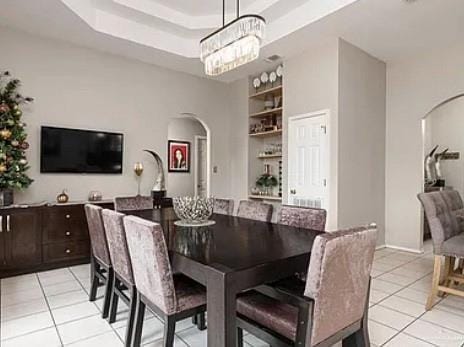 1806 E Flora Ave, Hidalgo, TX 78557 - dining area featuring arched walkways, light tile patterned floors, a chandelier, and built in features