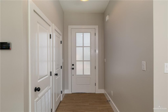 entryway with baseboards and wood finished floors