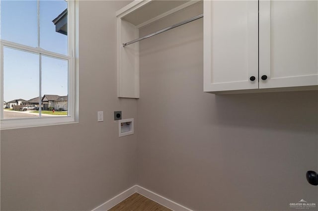 laundry room featuring hookup for a washing machine, wood finished floors, baseboards, hookup for an electric dryer, and cabinet space