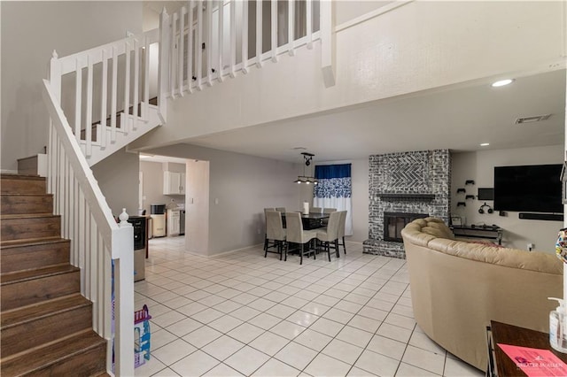 living room featuring light tile patterned floors and a brick fireplace