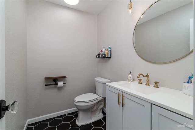 bathroom featuring tile patterned flooring, vanity, and toilet