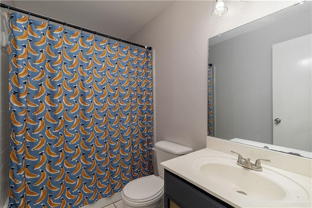 bathroom with tile patterned floors, vanity, toilet, and curtained shower