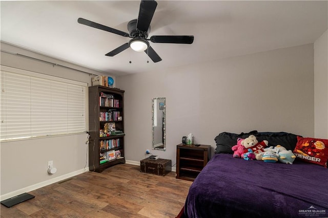 bedroom with hardwood / wood-style flooring and ceiling fan