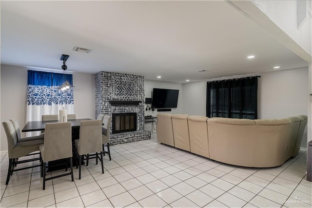 interior space with a brick fireplace and a notable chandelier