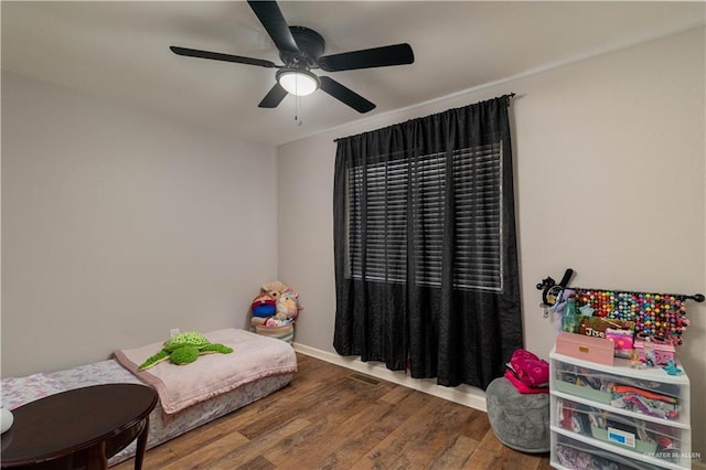 bedroom with wood-type flooring and ceiling fan