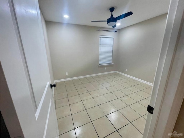 tiled empty room with ceiling fan