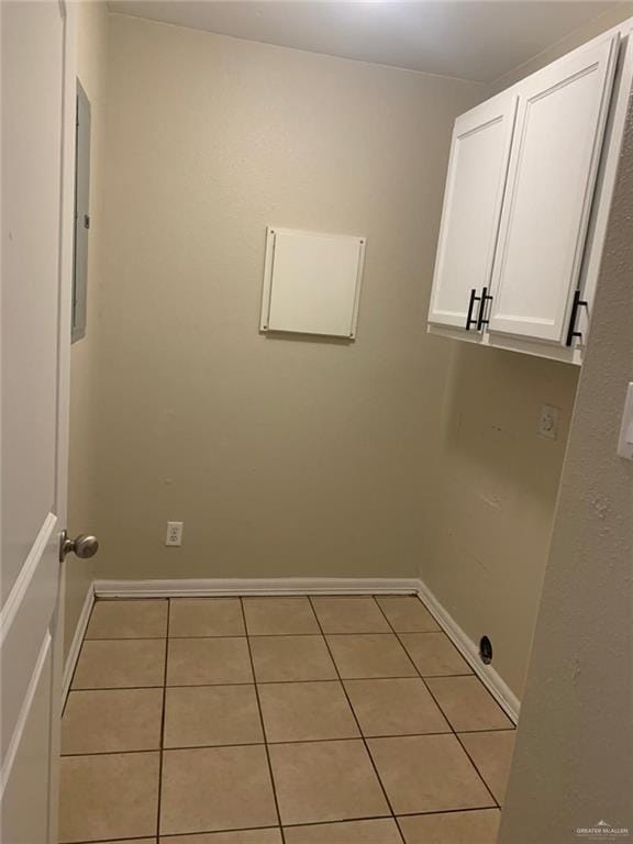 washroom with light tile patterned flooring and cabinets