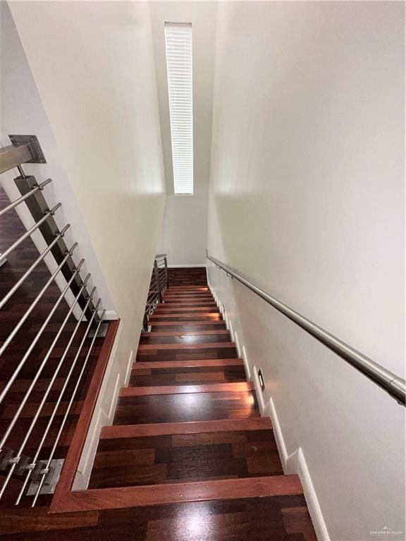 staircase with wood-type flooring