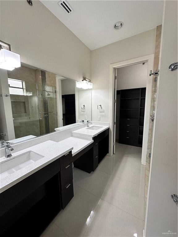 bathroom with tile patterned flooring, vanity, and an enclosed shower